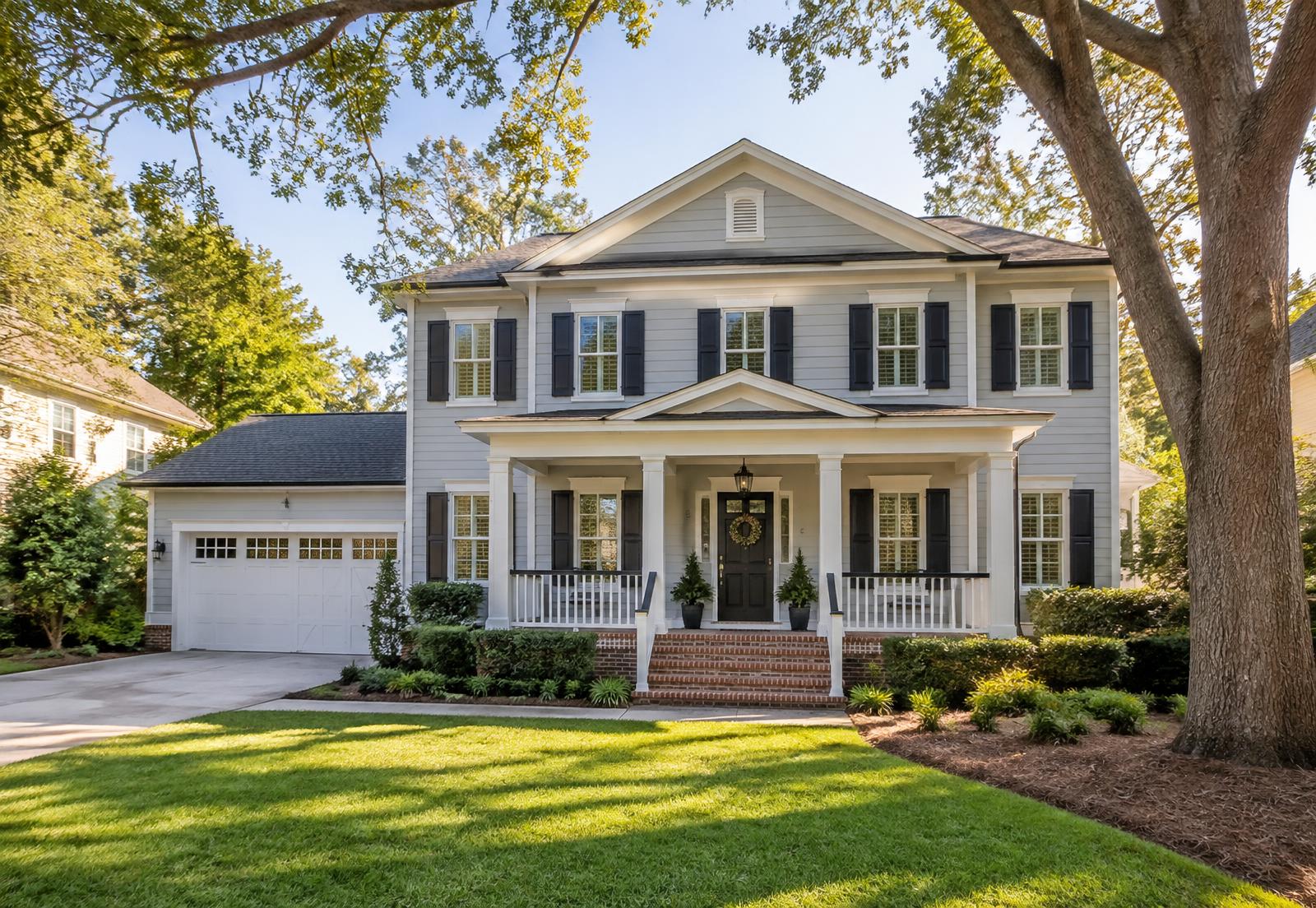 Freshly painted two-story North Florida home with crisp white trim and navy shutters